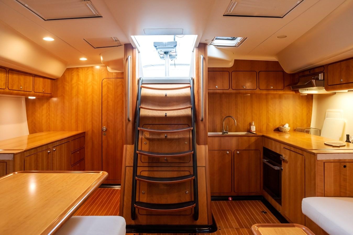a kitchen with wooden cabinets aboard MISTER A Yacht for Sale
