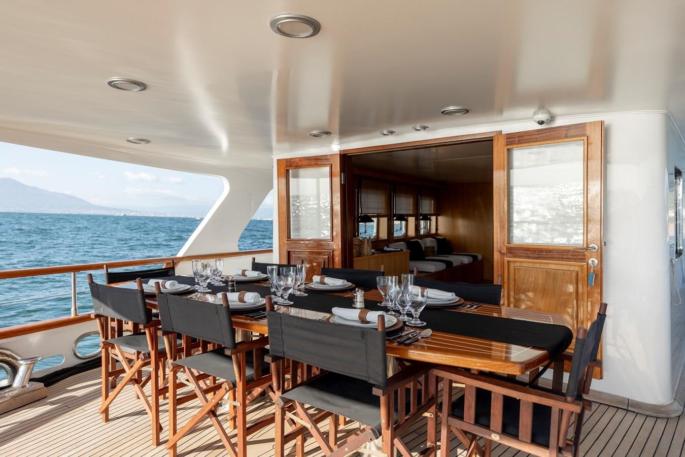 a dining table on a deck aboard SOUNION II Yacht for Sale
