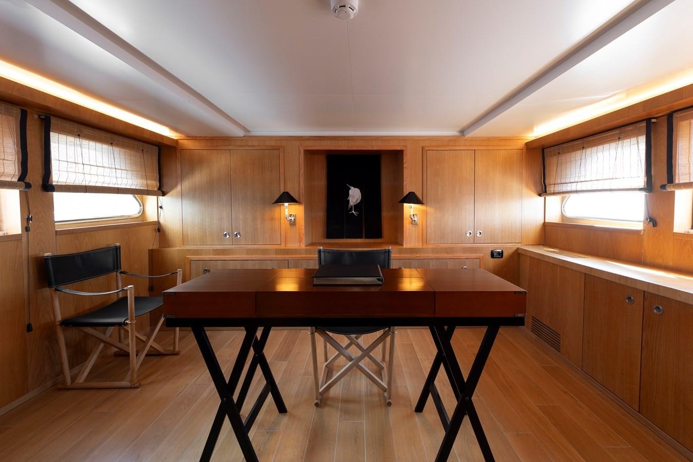 a kitchen with a bar and a table aboard SOUNION II Yacht for Sale