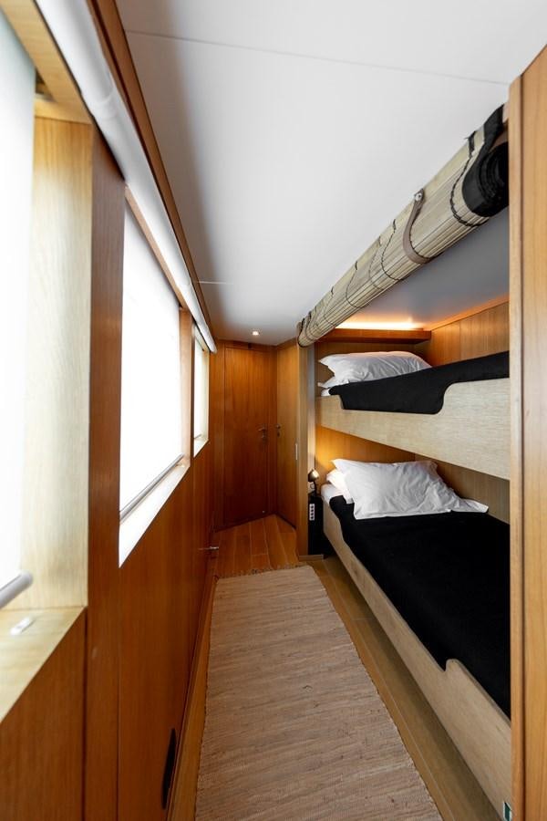 a room with a bed and a window aboard SOUNION II Yacht for Sale