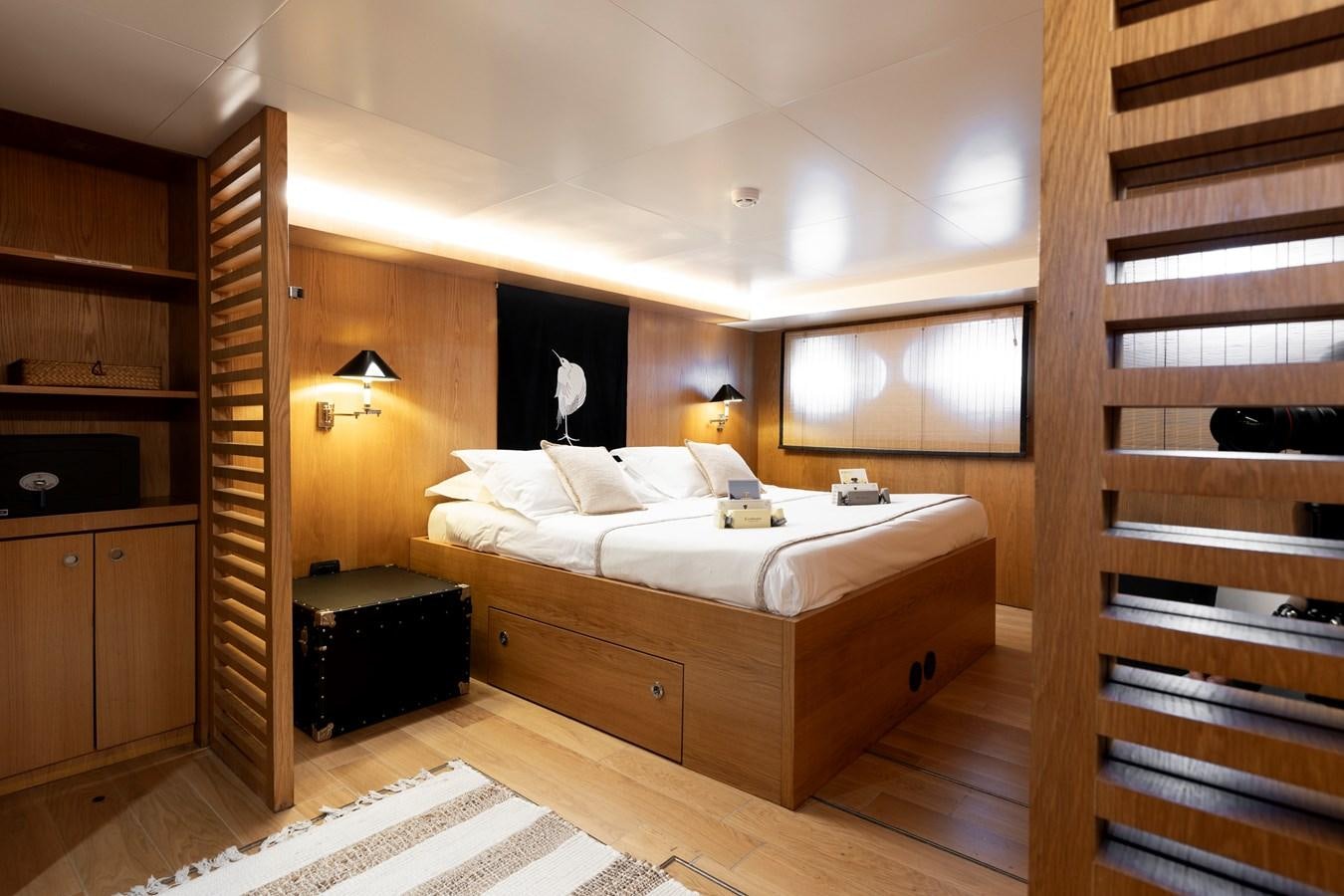 a bedroom with a bed and a closet aboard SOUNION II Yacht for Sale