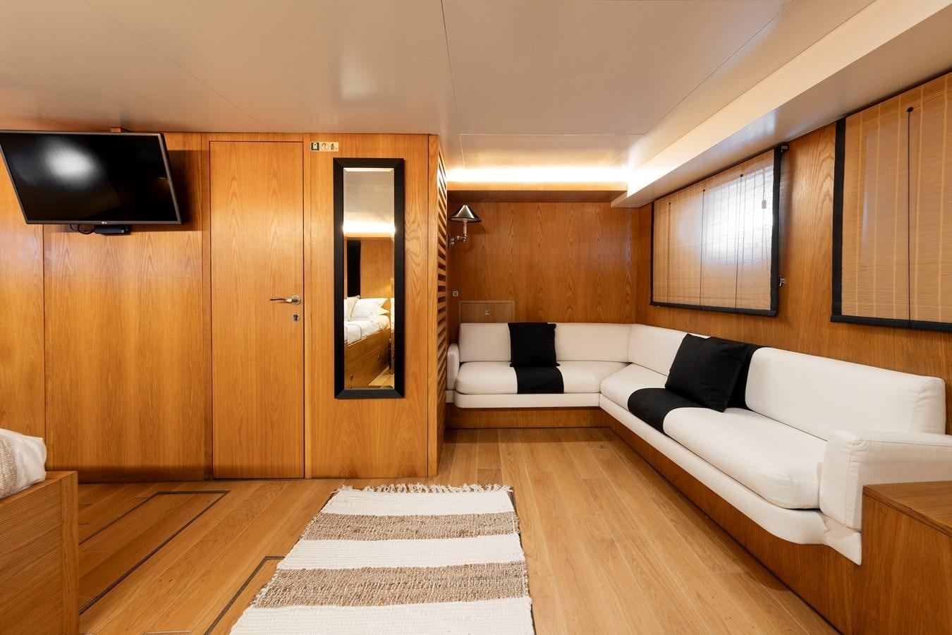 a room with a couch and a television aboard SOUNION II Yacht for Sale
