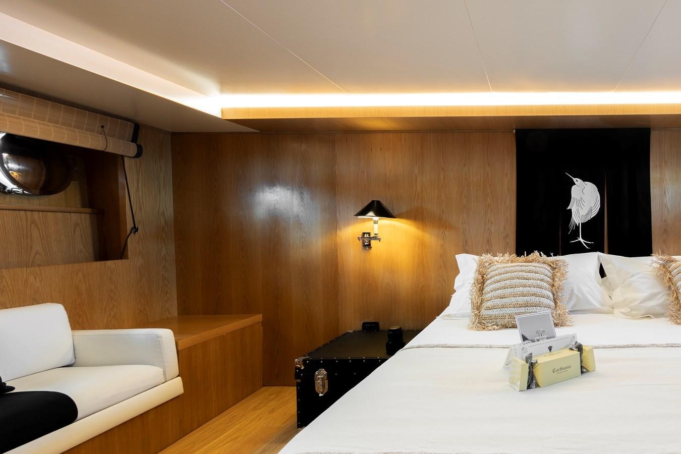 a room with a bed and a desk aboard SOUNION II Yacht for Sale