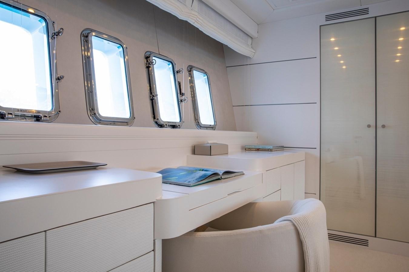 a room with a desk and chairs aboard DAYBOAT Yacht for Sale