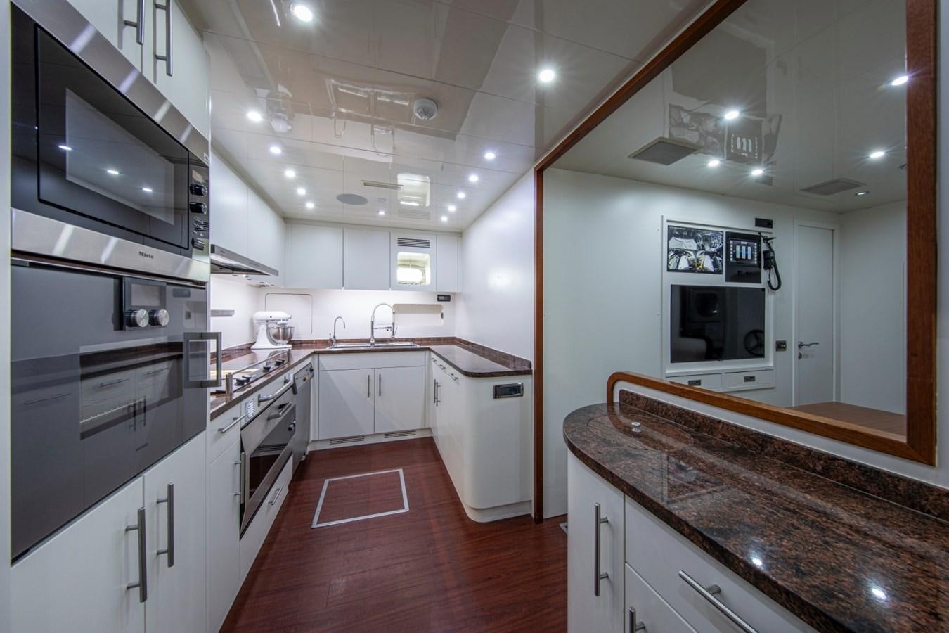 a kitchen with white cabinets aboard DAYBOAT Yacht for Sale
