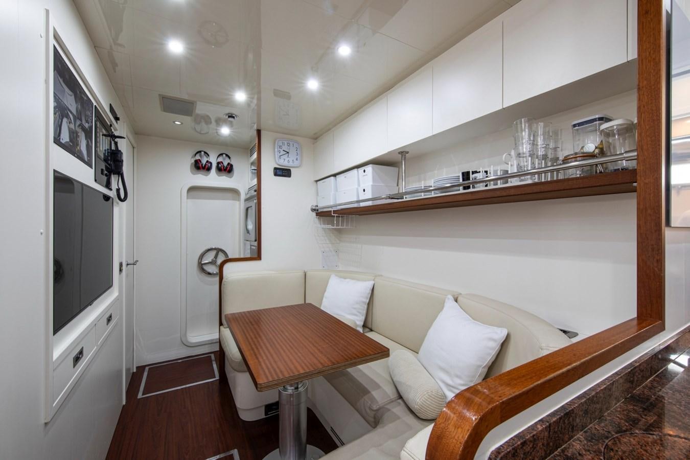 a room with a table and couch aboard DAYBOAT Yacht for Sale