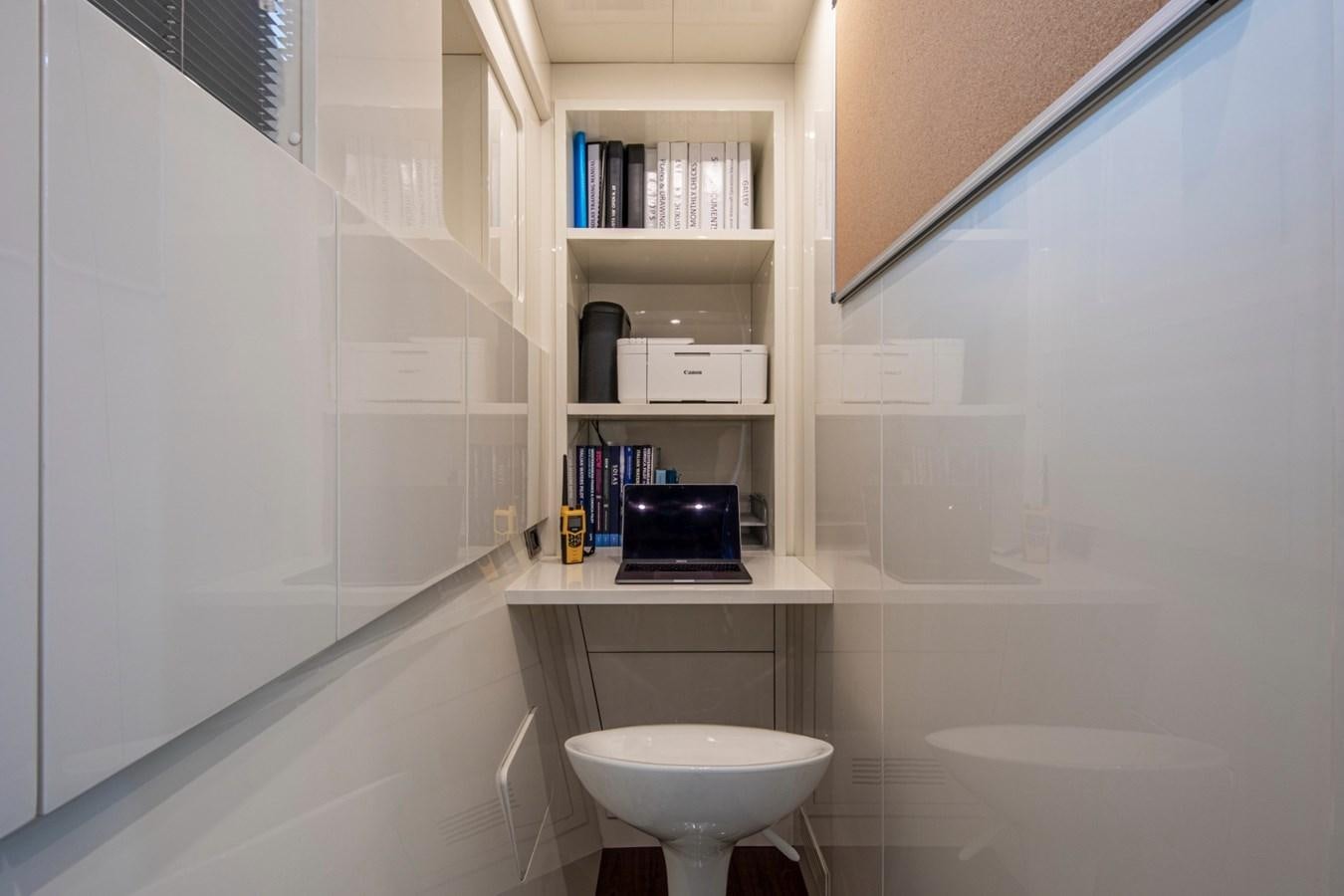 a bathroom with a small television on the wall aboard DAYBOAT Yacht for Sale