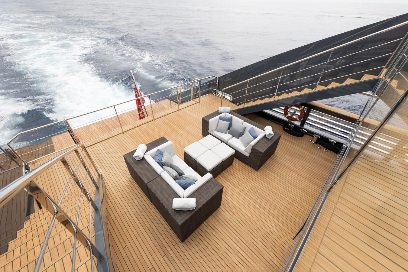 a deck with a couch and chairs on it by the ocean aboard OCEAN PEARL - FRACTIONAL OWNERSHIP VESSEL Yacht for Sale