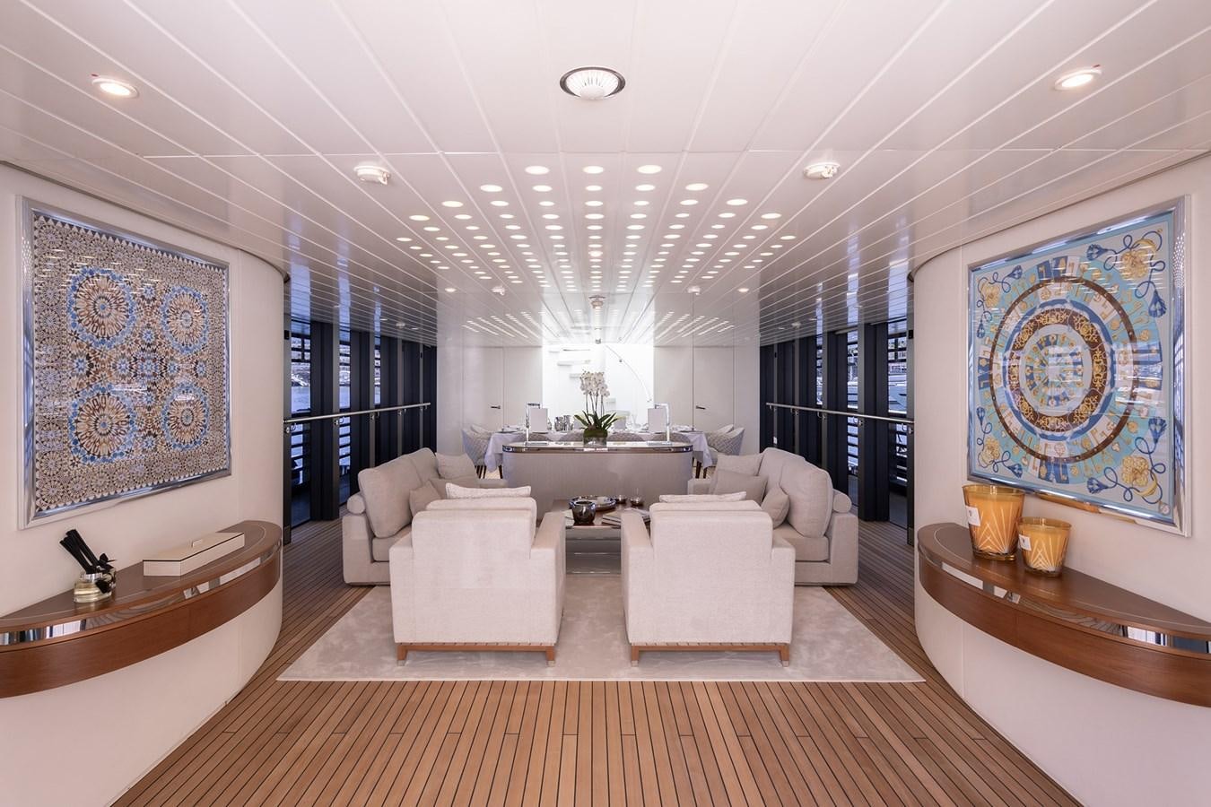 a large living room with white furniture aboard OCEAN PEARL - FRACTIONAL OWNERSHIP VESSEL Yacht for Sale