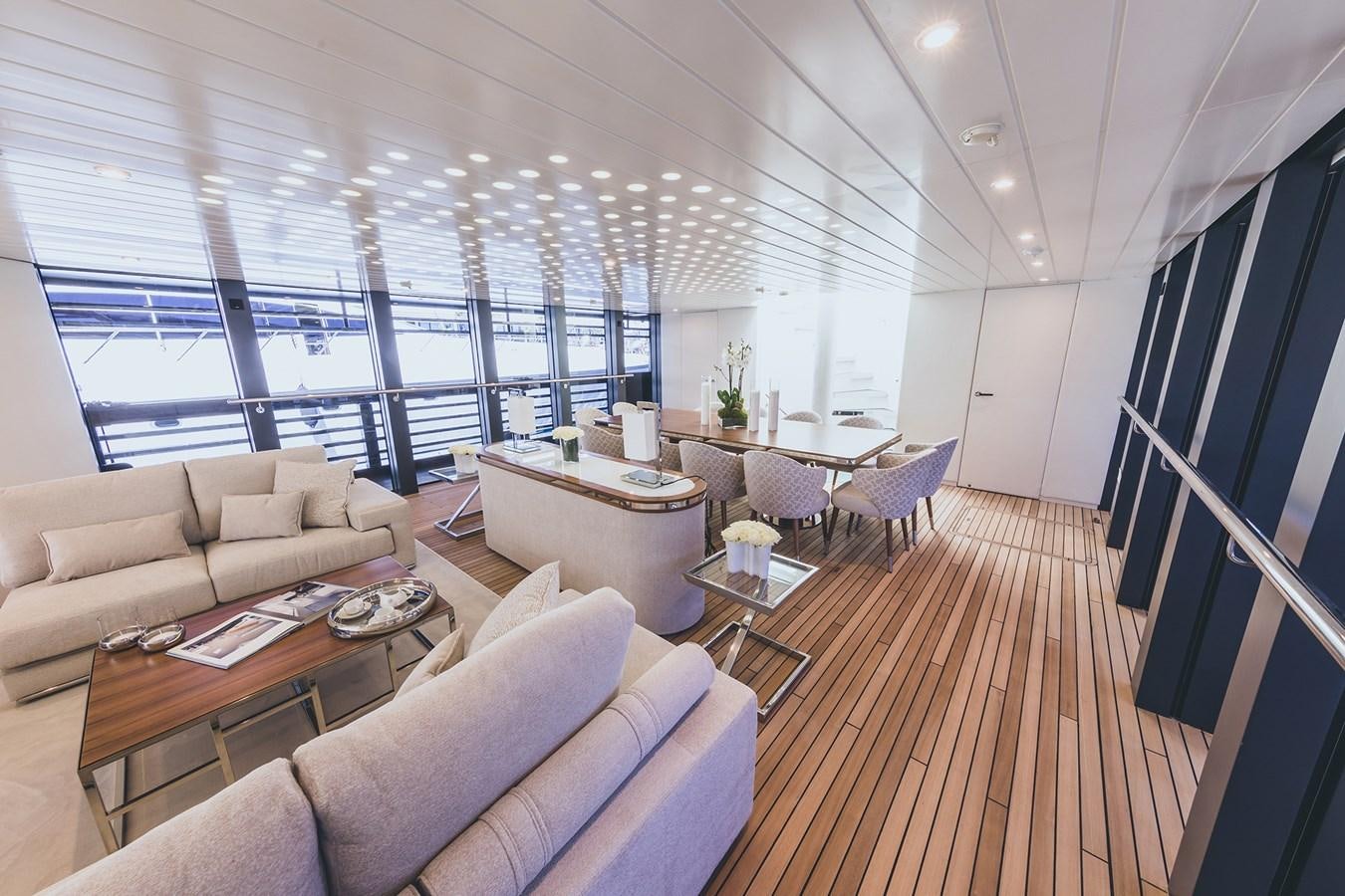 a room with a wood floor and a large window with a wood floor aboard OCEAN PEARL - FRACTIONAL OWNERSHIP VESSEL Yacht for Sale