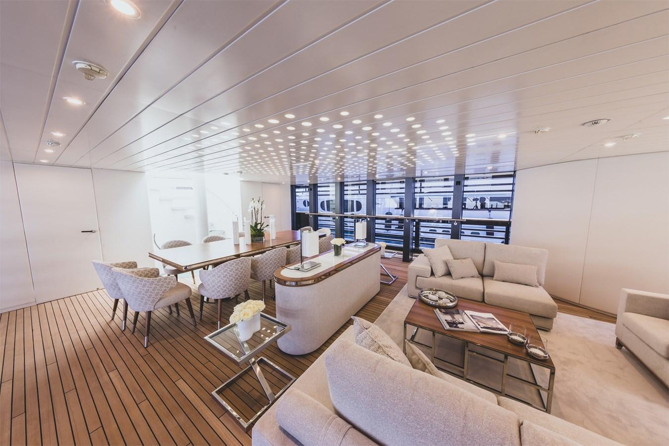 a living room with a wood floor aboard OCEAN PEARL - FRACTIONAL OWNERSHIP VESSEL Yacht for Sale