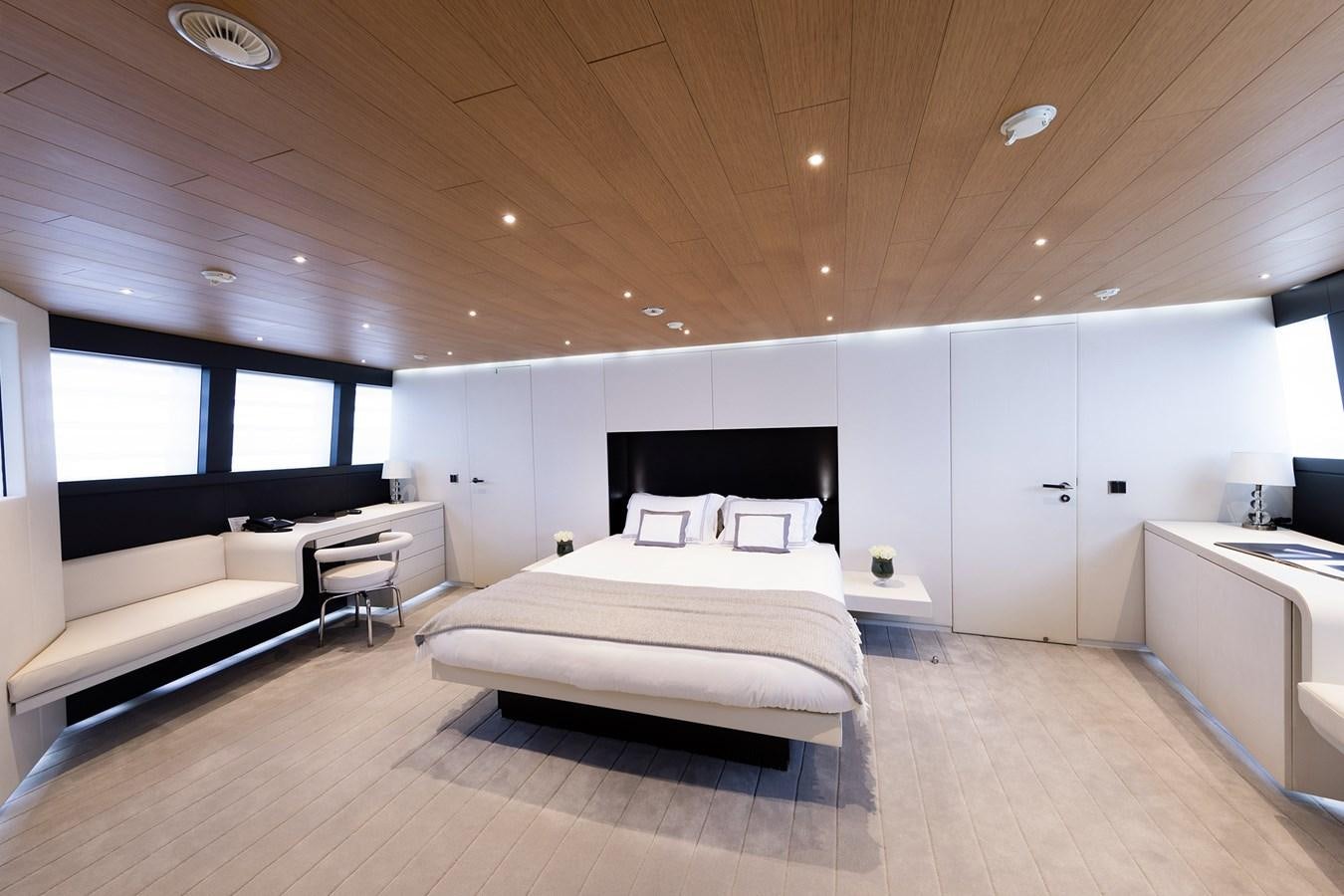 a room with a bed and a couch aboard OCEAN PEARL - FRACTIONAL OWNERSHIP VESSEL Yacht for Sale