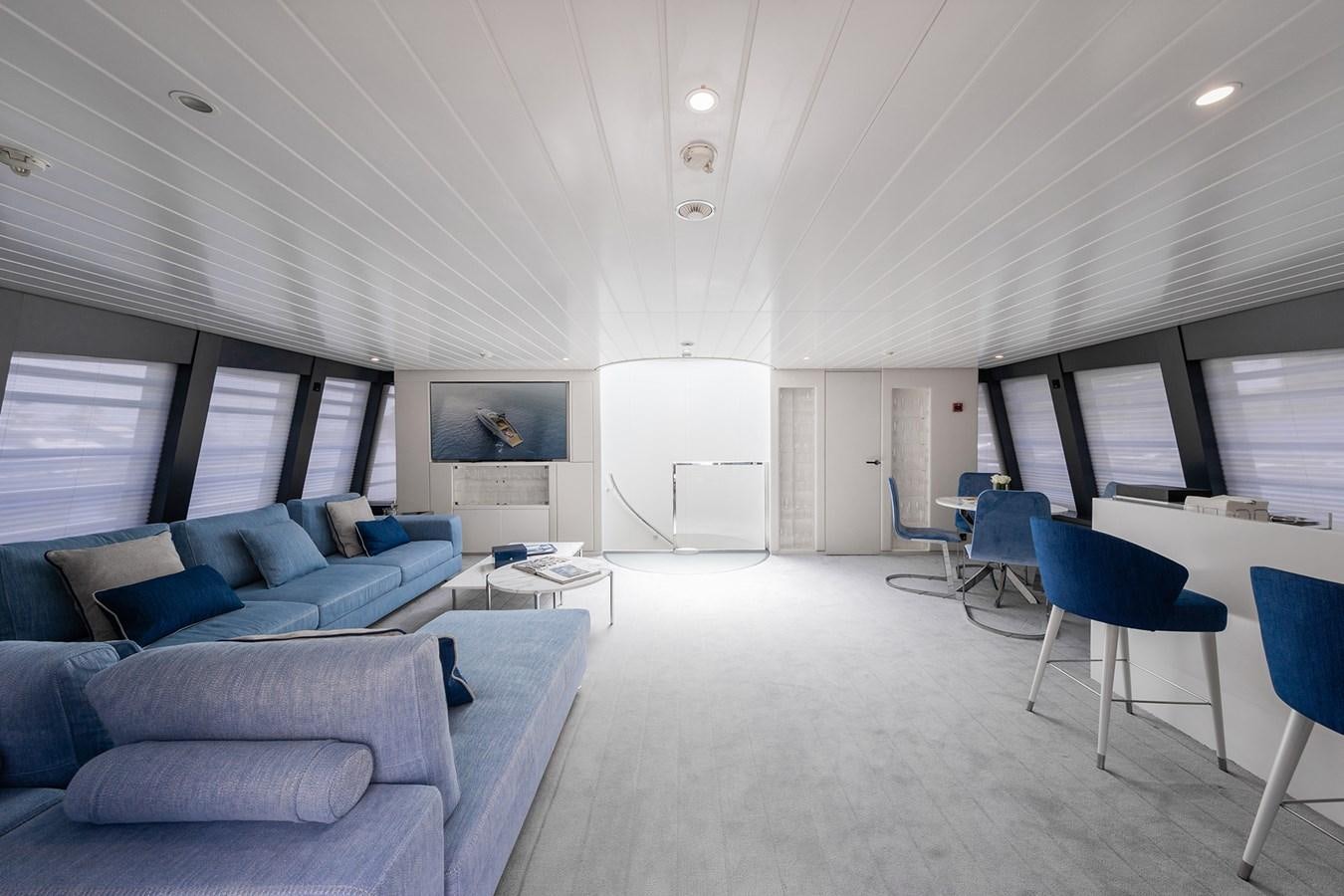 a room with a couch and a table and chairs aboard OCEAN PEARL - FRACTIONAL OWNERSHIP VESSEL Yacht for Sale