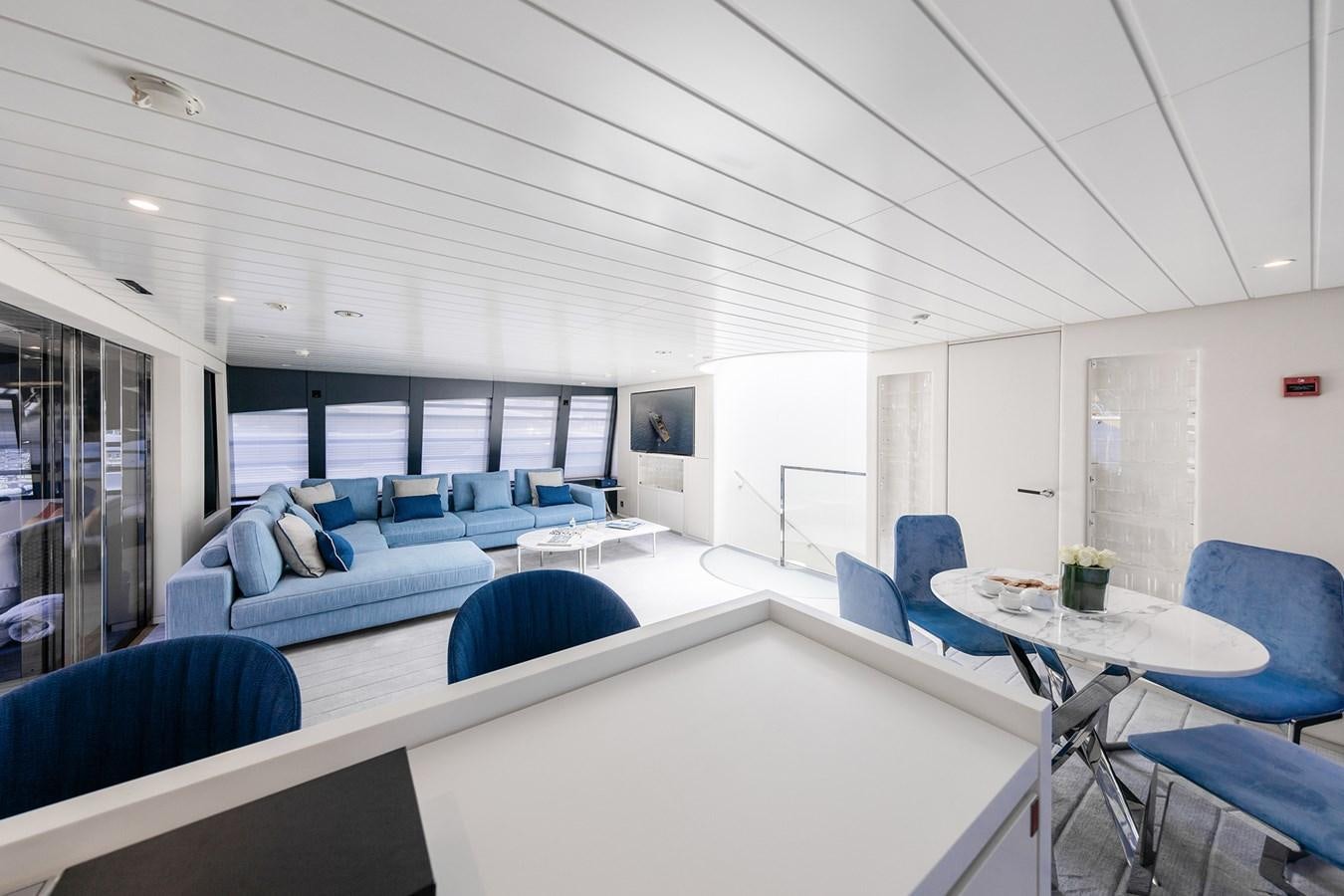 a room with a couch and a table aboard OCEAN PEARL - FRACTIONAL OWNERSHIP VESSEL Yacht for Sale