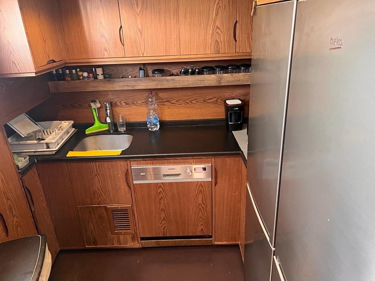 a kitchen with a sink and a refrigerator aboard AYO Yacht for Sale