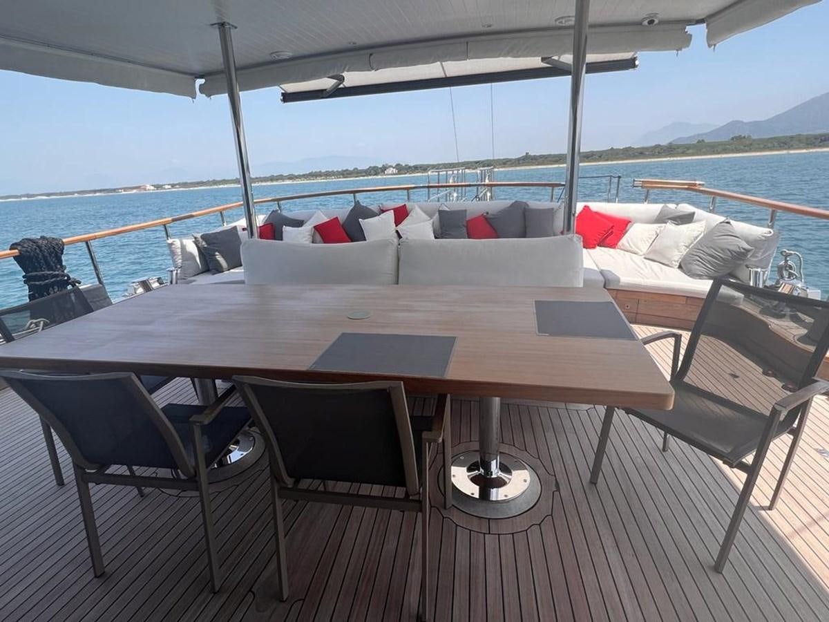 a table with chairs on it aboard AYO Yacht for Sale