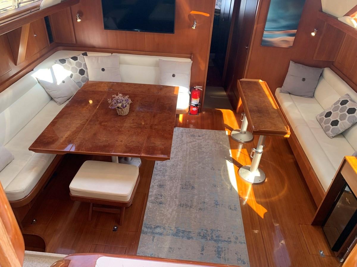 a room with a table and chairs aboard LUCKY B Yacht for Sale