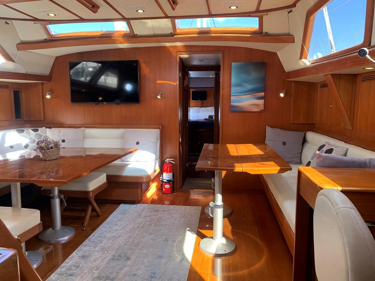 a room with a couch and a television aboard LUCKY B Yacht for Sale