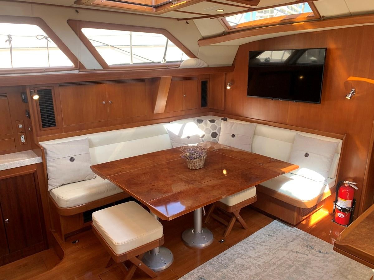 a room with a table and chairs aboard LUCKY B Yacht for Sale