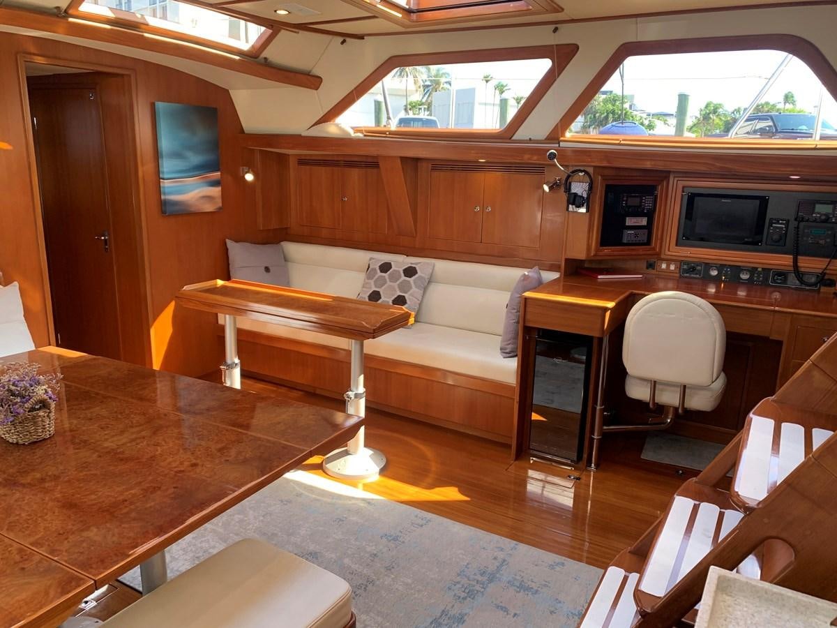 a room with a couch and a table aboard LUCKY B Yacht for Sale
