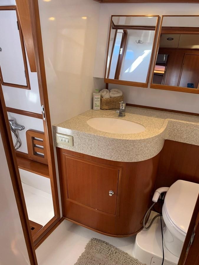 a bathroom with a sink and a mirror aboard LUCKY B Yacht for Sale