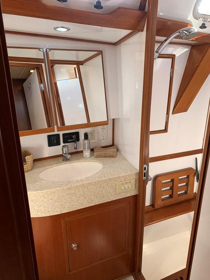 a bathroom with a sink and a mirror aboard LUCKY B Yacht for Sale
