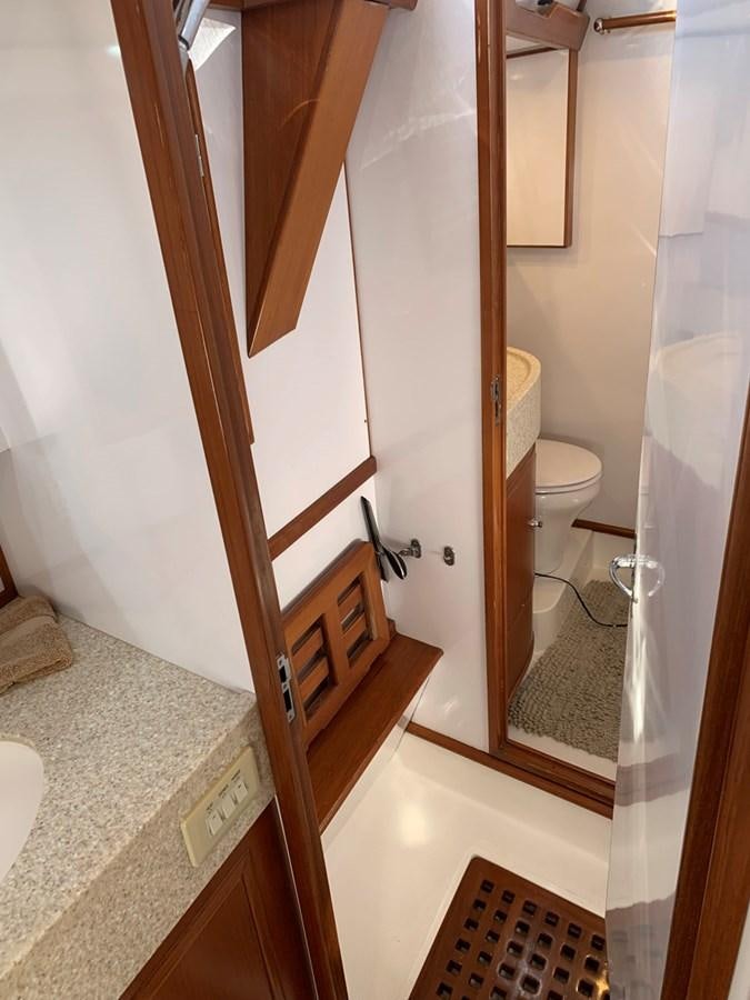 a bathroom with a toilet and a sink aboard LUCKY B Yacht for Sale