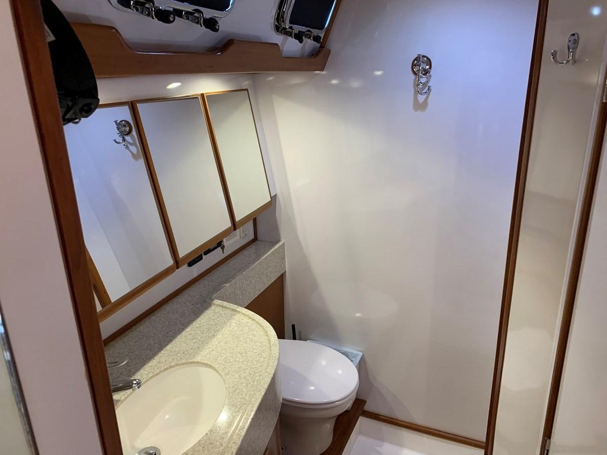 a bathroom with a toilet and a sink aboard LUCKY B Yacht for Sale