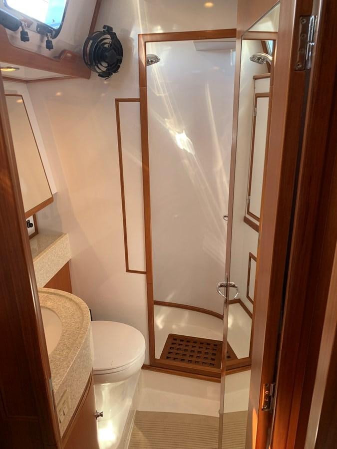 a bathroom with a glass shower door aboard LUCKY B Yacht for Sale