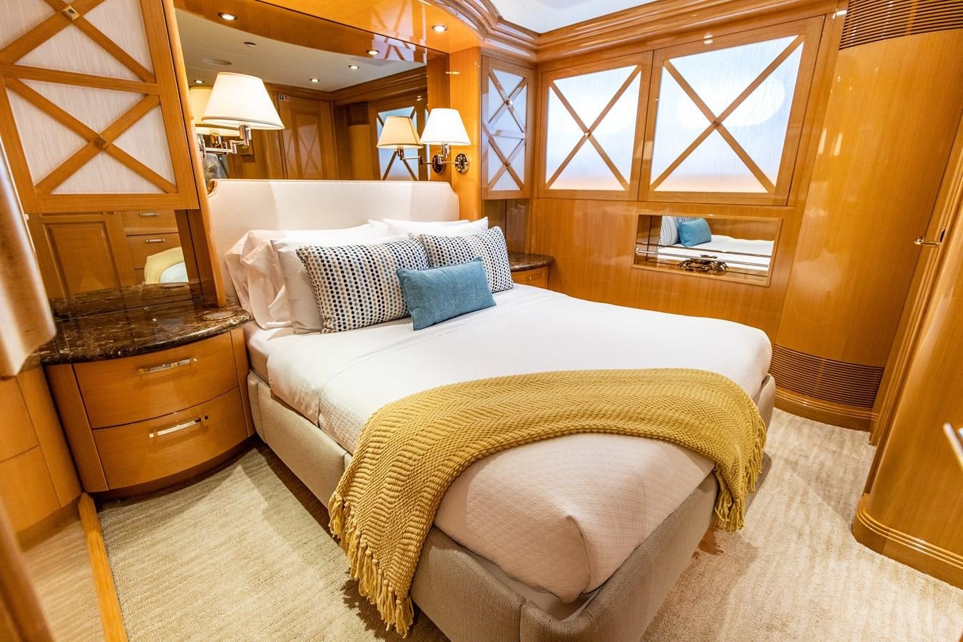 a bedroom with a bed and a dresser aboard SEAQUEST Yacht for Sale