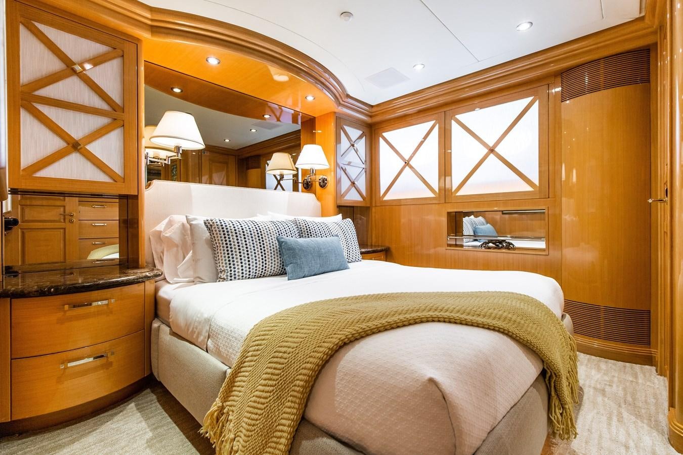 a bedroom with a bed and a mirror aboard SEAQUEST Yacht for Sale