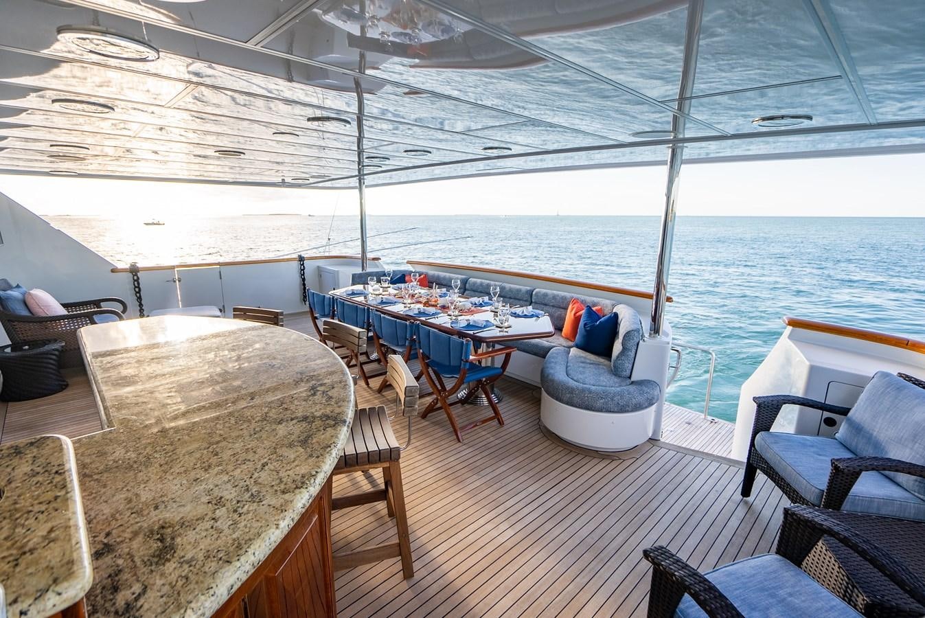 a deck with a table and chairs on it aboard SEAQUEST Yacht for Sale