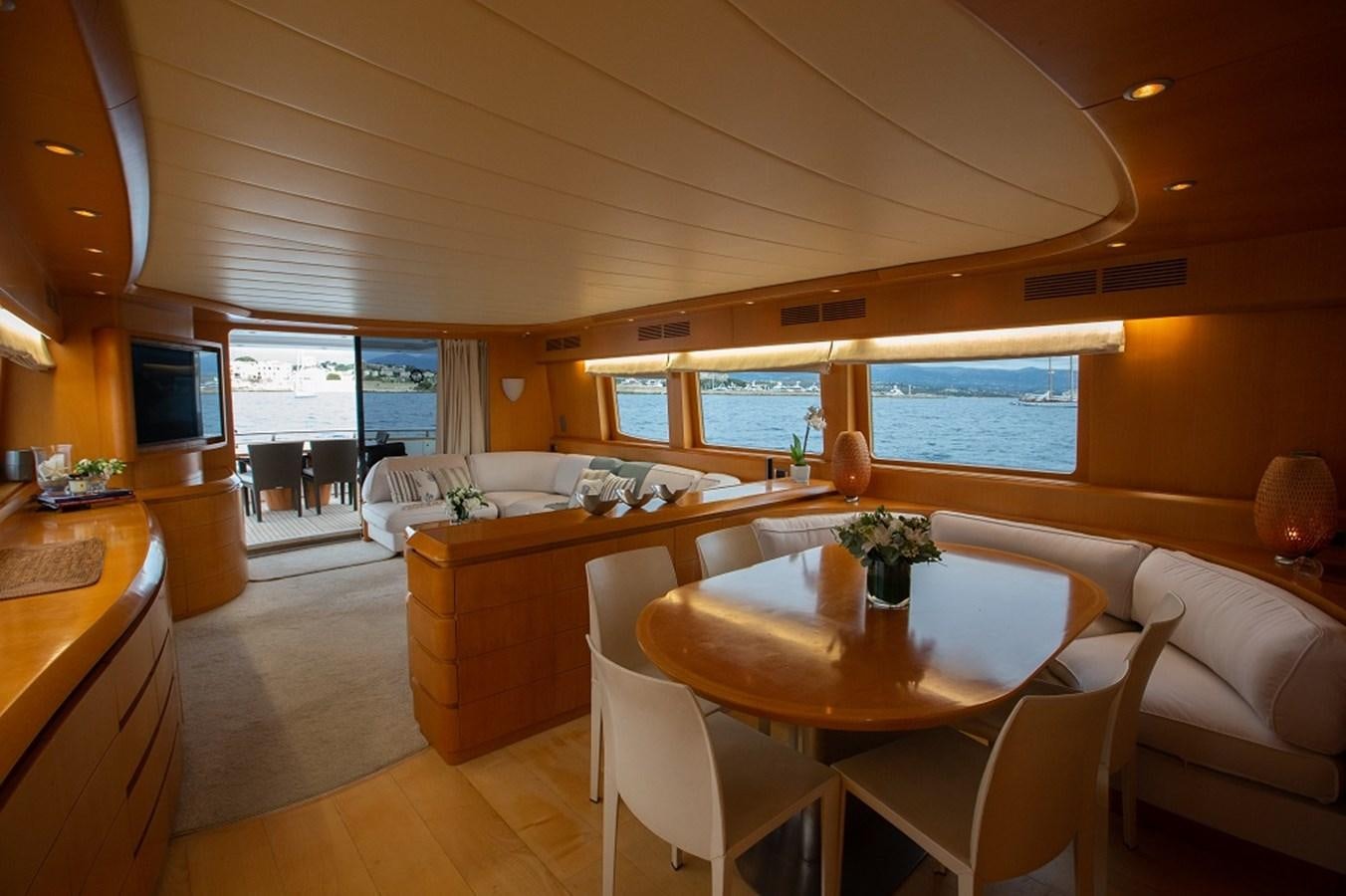 a large living room with a dining table and chairs aboard MEME Yacht for Sale