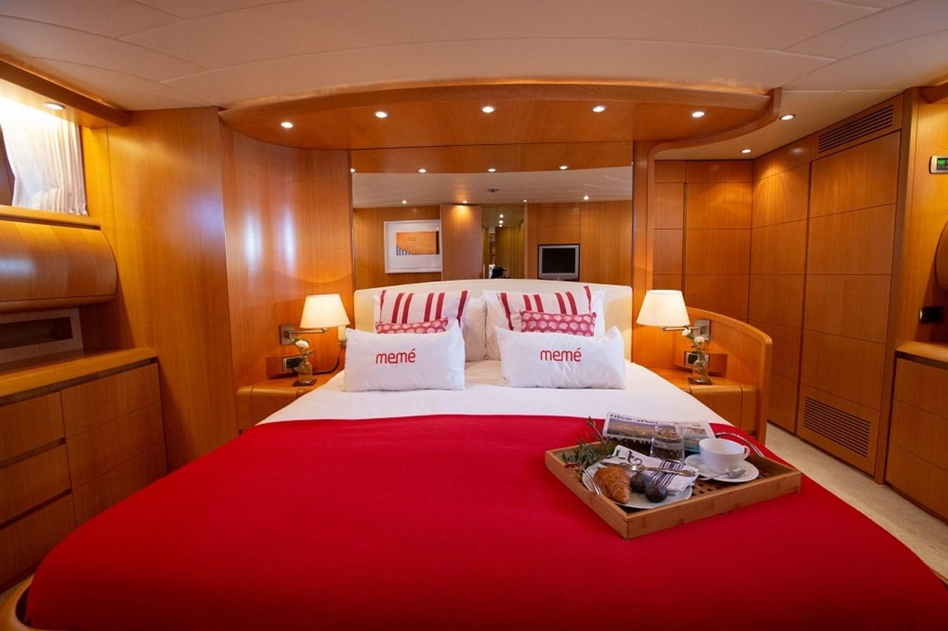 a bed with a tray of food on it aboard MEME Yacht for Sale