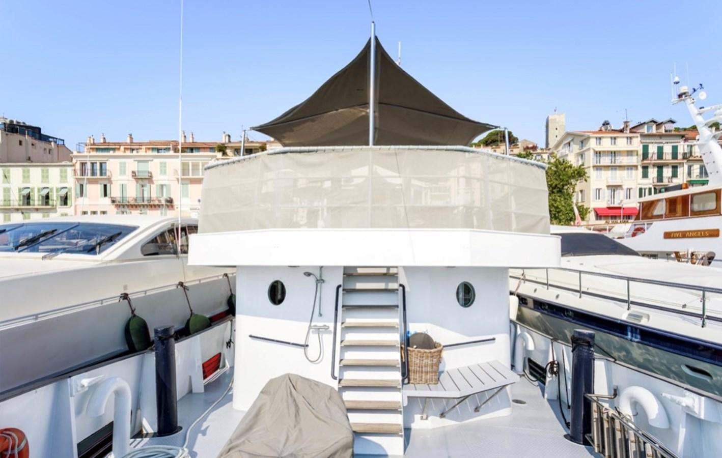 a boat with a white awning aboard FAMILY Yacht for Sale