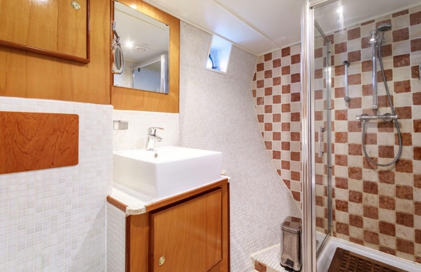 a bathroom with a sink and shower aboard FAMILY Yacht for Sale