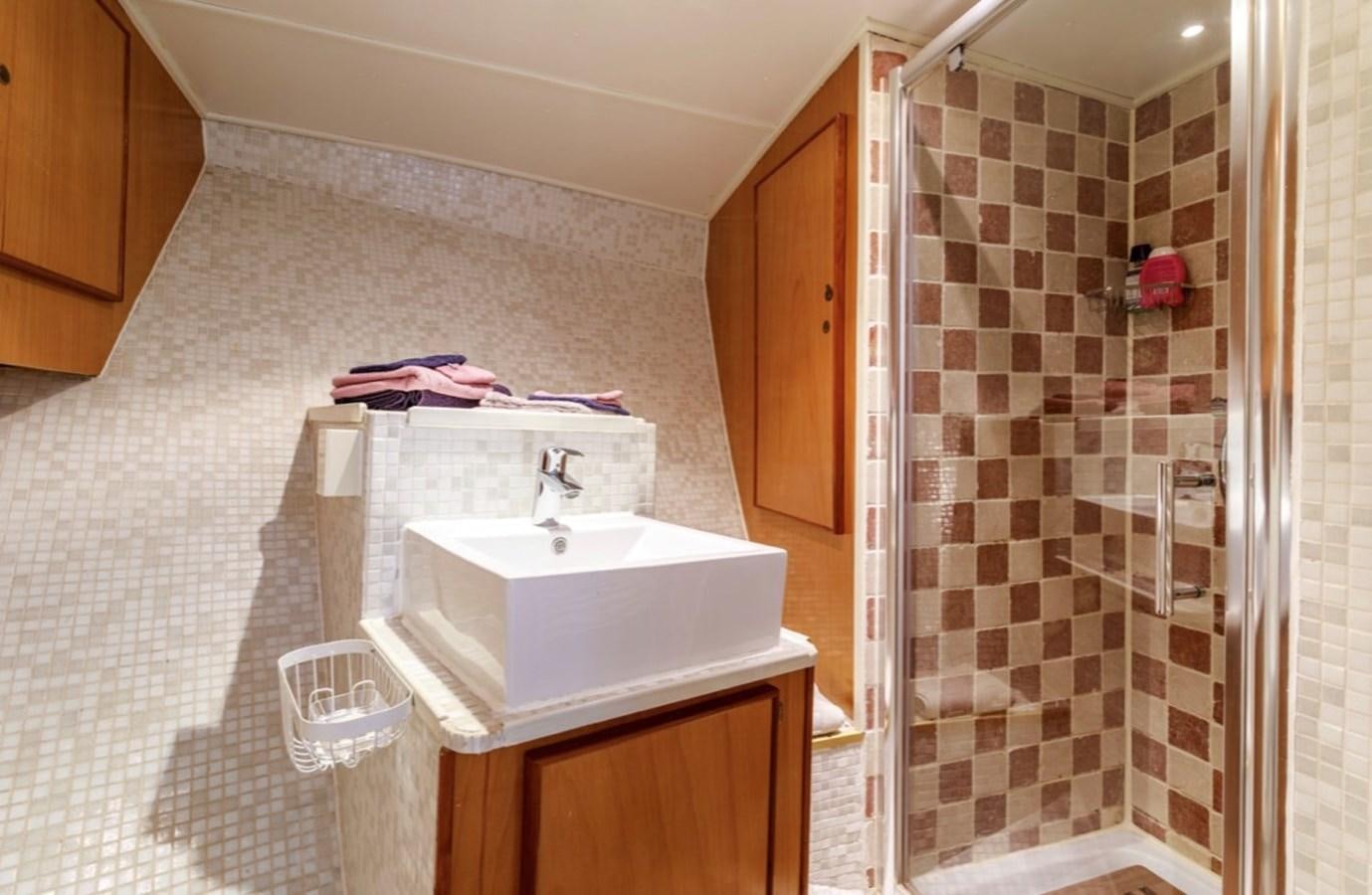 a bathroom with a sink and shower aboard FAMILY Yacht for Sale