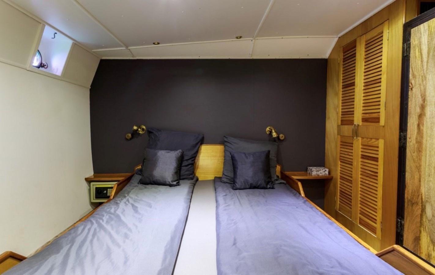a bedroom with two beds aboard FAMILY Yacht for Sale