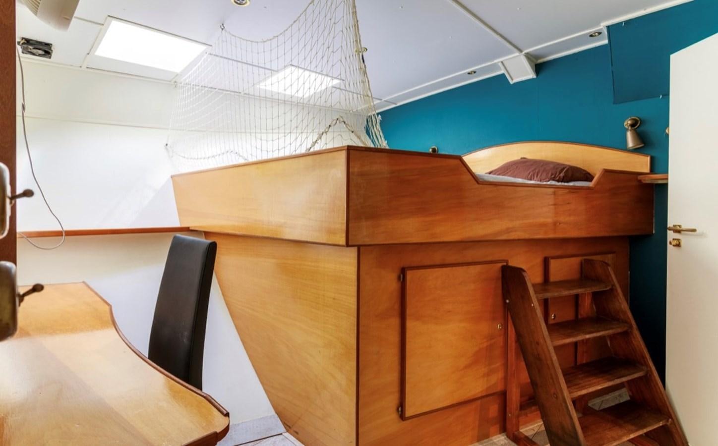 a wooden desk with a chair aboard FAMILY Yacht for Sale