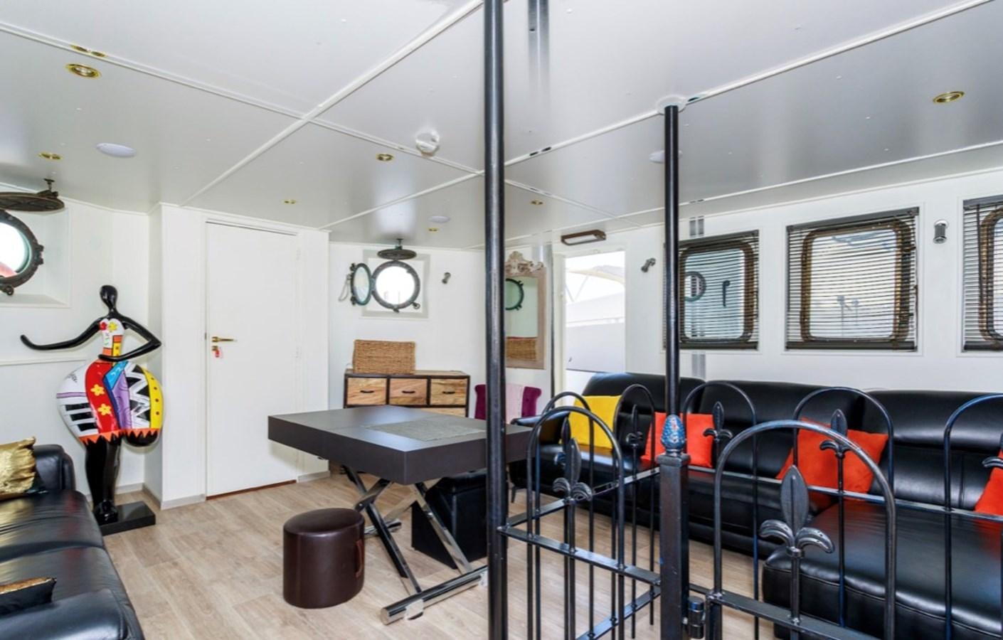 a room with a table and chairs aboard FAMILY Yacht for Sale