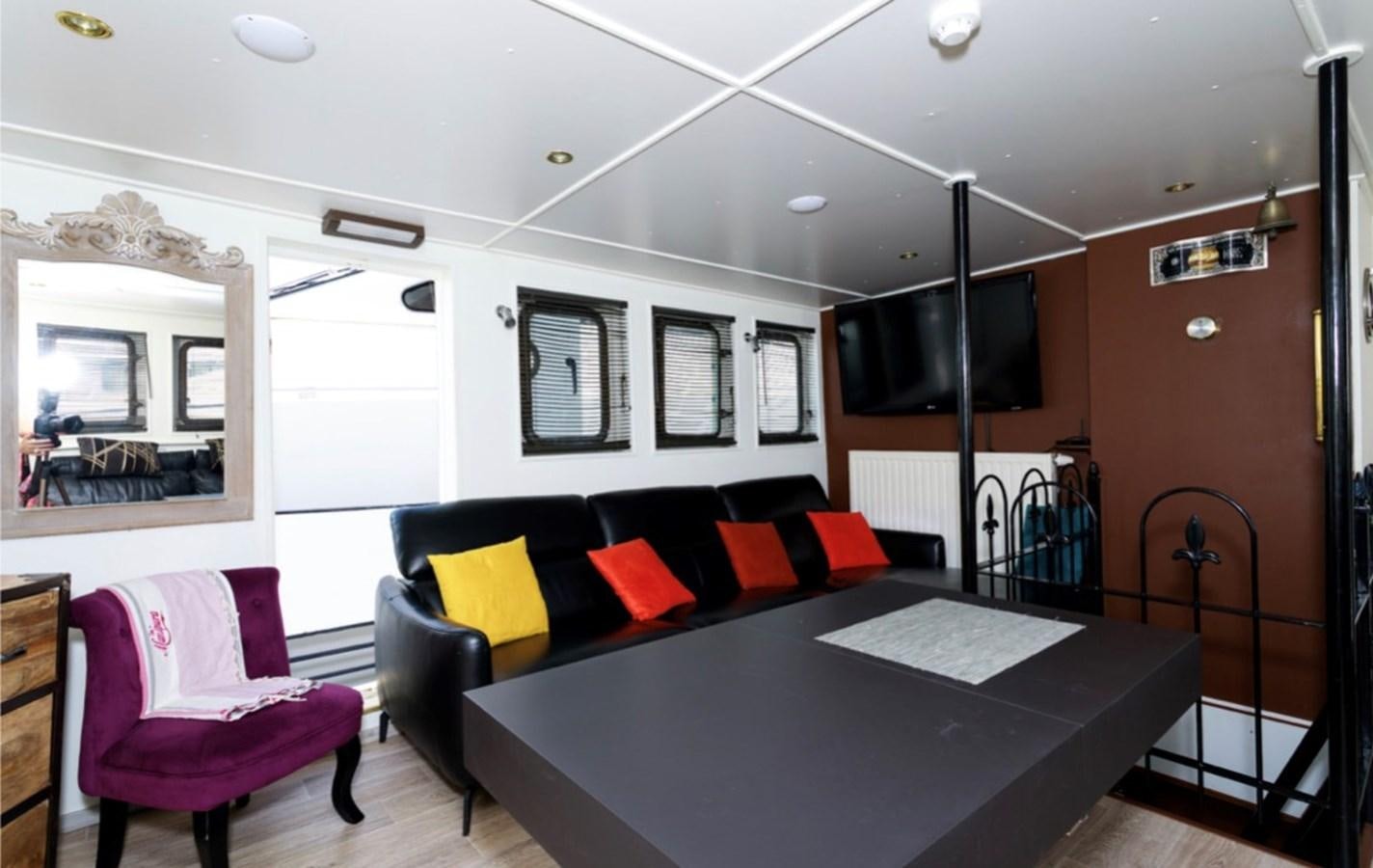 a room with a couch and a table aboard FAMILY Yacht for Sale
