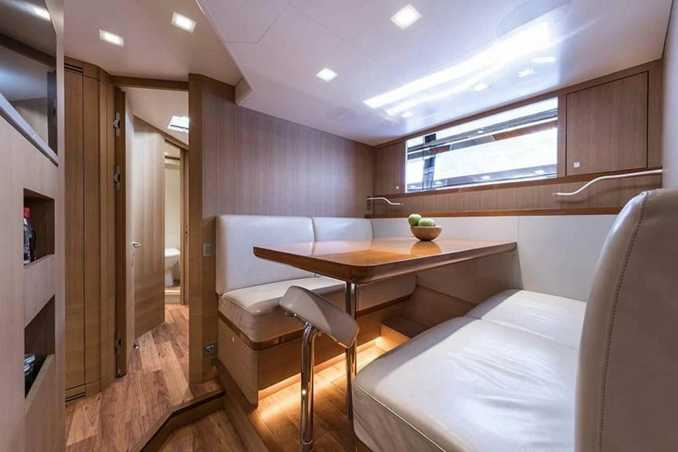 a room with a table and couch aboard RIBELLE Yacht for Sale