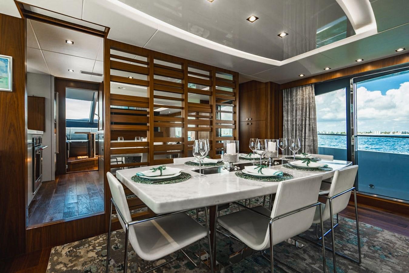 a large dining table with white chairs aboard GALLIVANT Yacht for Sale