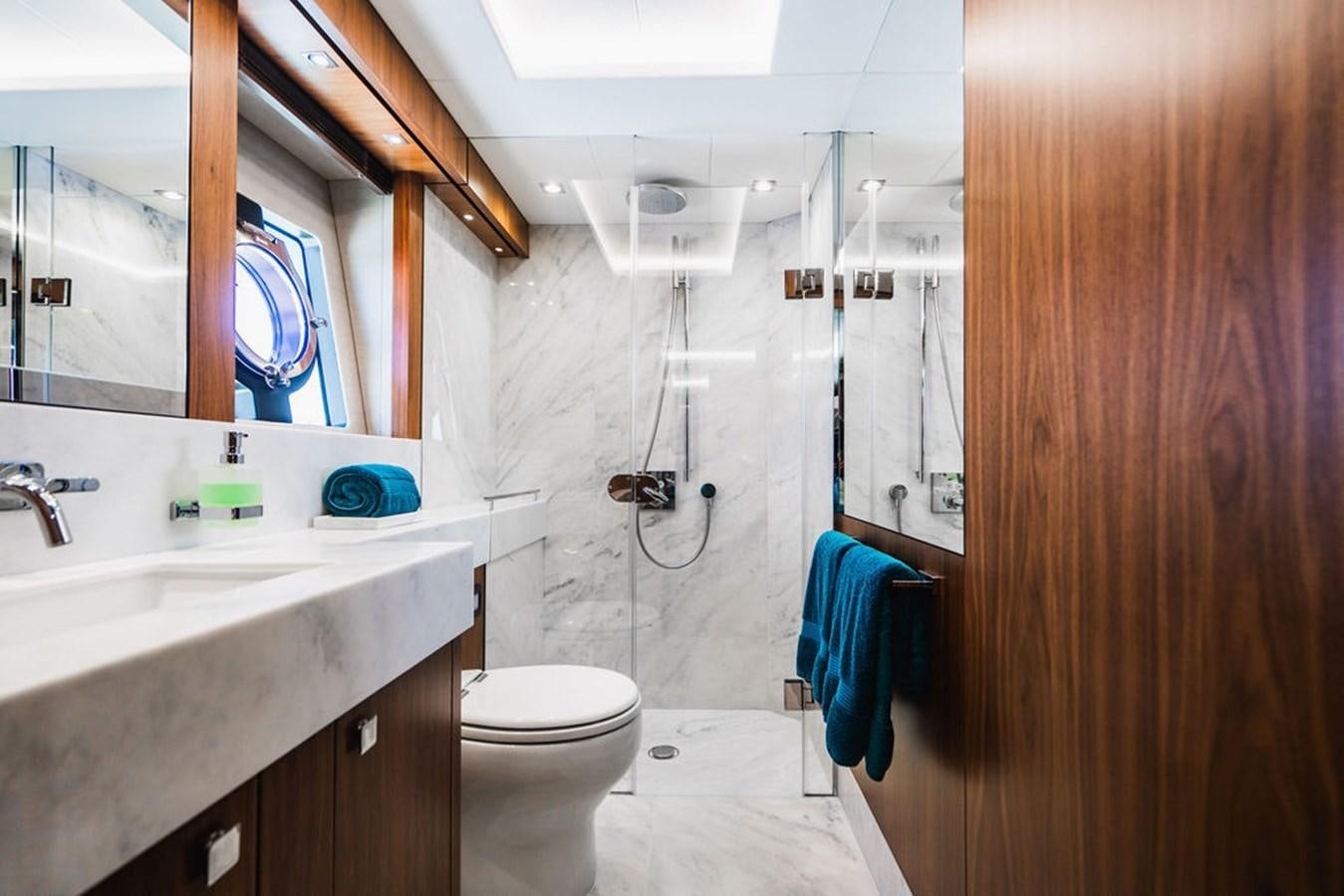 a bathroom with a sink toilet and a mirror aboard GALLIVANT Yacht for Sale