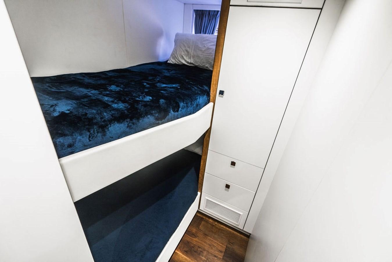 a bed with a blue blanket aboard GALLIVANT Yacht for Sale