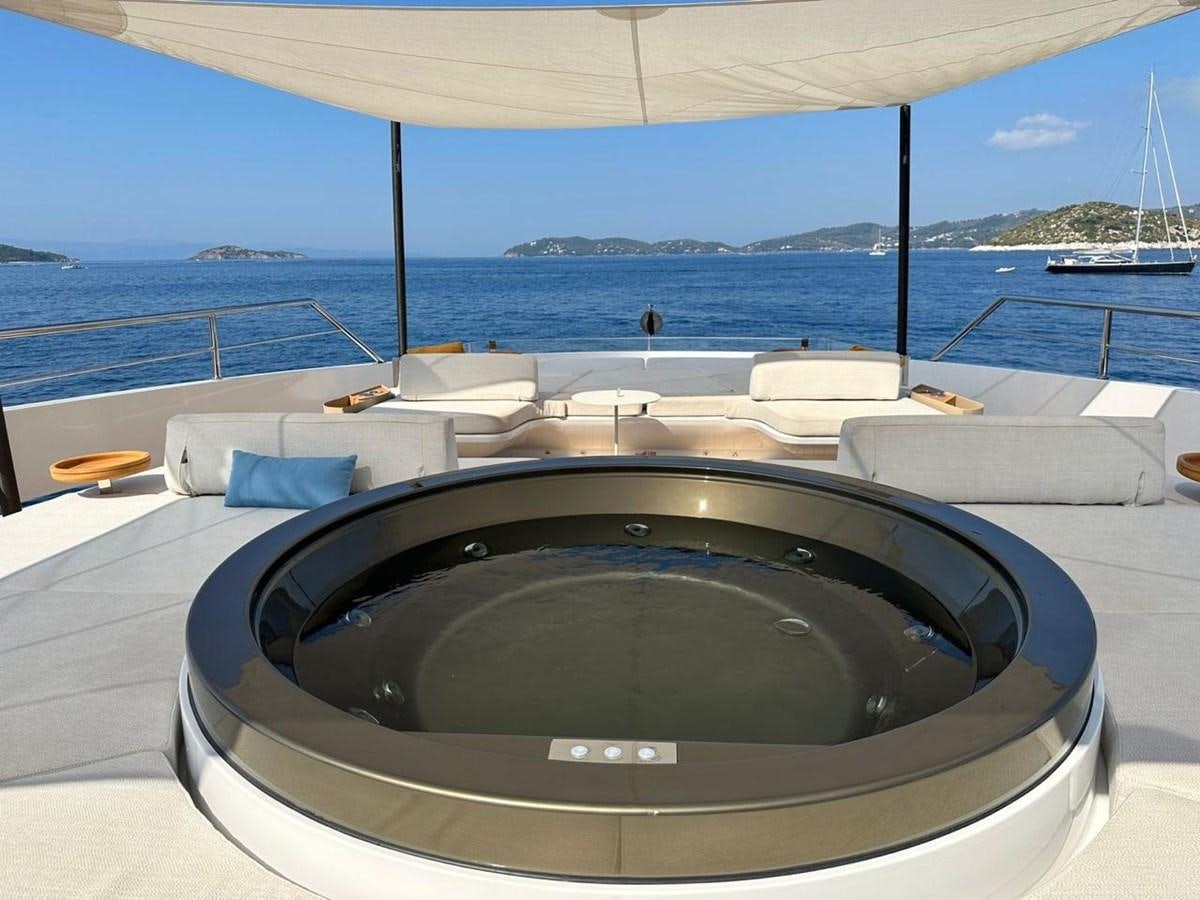 a large jacuzzi on a deck overlooking a body of water aboard NG Yacht for Sale