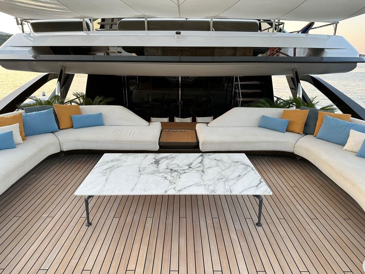 a large room with a bed and a table aboard NG Yacht for Sale