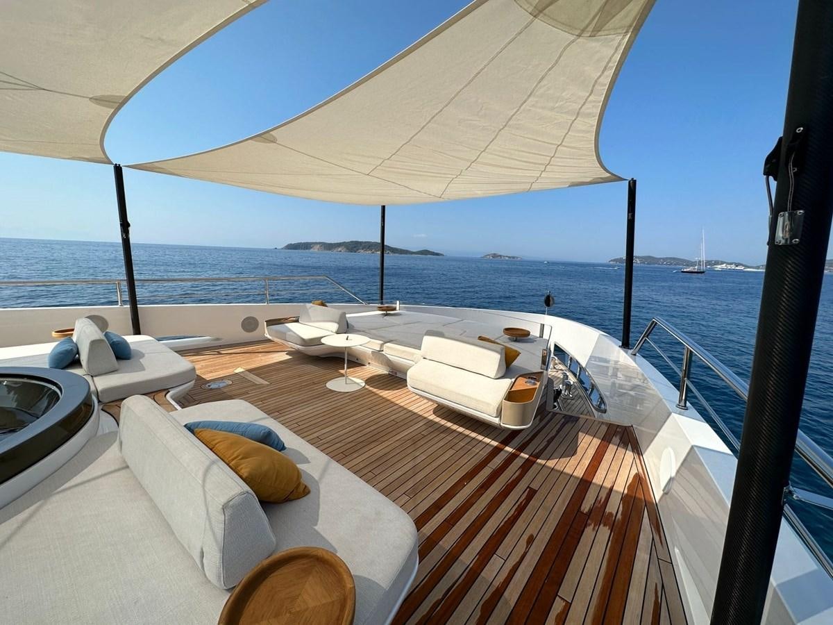 a lounge area with a large umbrella aboard NG Yacht for Sale