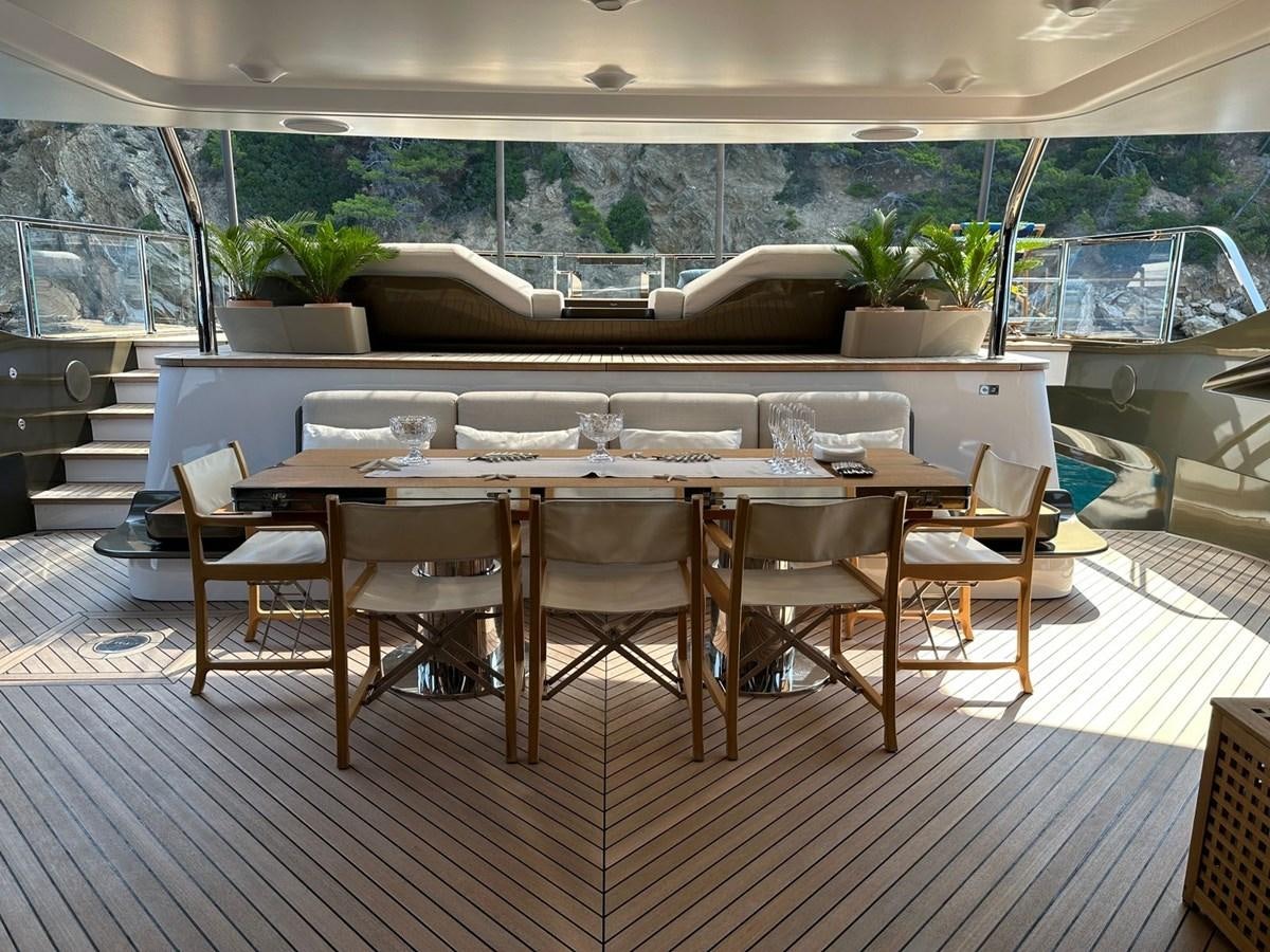 a dining room with a table and chairs aboard NG Yacht for Sale