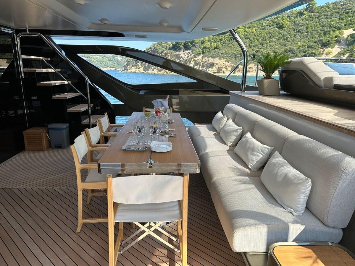 a table and chairs on a deck aboard NG Yacht for Sale